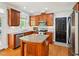 Well-lit kitchen features a granite island, stainless steel appliances, and ample cabinet storage at 5708 Butter Churn Way, Fuquay Varina, NC 27526
