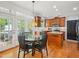 Sunlit kitchen with a breakfast nook, wood cabinets, and stainless steel appliances at 5708 Butter Churn Way, Fuquay Varina, NC 27526
