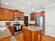 Spacious kitchen with granite island, stainless steel appliances, and white subway tile backsplash at 5708 Butter Churn Way, Fuquay Varina, NC 27526