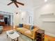 Bright and airy living room with hardwood floors, a comfortable couch, and ample natural light at 5708 Butter Churn Way, Fuquay Varina, NC 27526