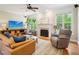 Cozy living room with fireplace, ceiling fan, and comfortable seating arrangement at 5708 Butter Churn Way, Fuquay Varina, NC 27526