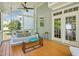 Relaxing screened-in porch with swing bed, wood floors, and tranquil backyard view at 5708 Butter Churn Way, Fuquay Varina, NC 27526