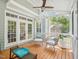 Inviting screened-in porch with seating area, ceiling fan, and tranquil outdoor view at 5708 Butter Churn Way, Fuquay Varina, NC 27526