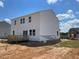 Two-story home boasts a wooden deck and vinyl siding under a bright, sunny sky at 59 Grove Township Way, Angier, NC 27501