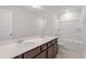 Modern bathroom with a double sink vanity, framed mirror, bathtub, and shower offering comfort and functionality at 59 Grove Township Way, Angier, NC 27501