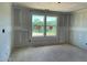 Bedroom featuring unfinished drywall, and double window views of lush greenery, ready for your personal touch at 59 Grove Township Way, Angier, NC 27501