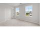 Bright bedroom featuring two large windows that offers plenty of natural light and scenic views at 59 Grove Township Way, Angier, NC 27501
