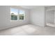 Spacious bedroom featuring plush carpeting, neutral colors, and large window at 59 Grove Township Way, Angier, NC 27501