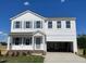Charming two-story home with gray shutters, an attached two-car garage, and a well-maintained lawn at 59 Grove Township Way, Angier, NC 27501