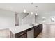 Gourmet kitchen featuring an island with seating, stainless steel appliances, and easy access to the living area at 59 Grove Township Way, Angier, NC 27501