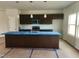 Modern kitchen with dark cabinets, stainless steel appliances, and a large island at 59 Grove Township Way, Angier, NC 27501