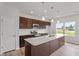 Modern kitchen featuring a large island, stainless steel appliances, and sleek countertops for culinary enthusiasts at 59 Grove Township Way, Angier, NC 27501