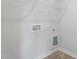 Spacious laundry room featuring convenient hookups, ample space, and a wire shelf for easy storage solutions at 59 Grove Township Way, Angier, NC 27501