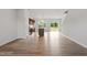Open-concept living area showcasing wood floors, access to the deck, and a view of the contemporary kitchen space at 59 Grove Township Way, Angier, NC 27501