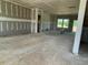 Open-concept living area with unfinished flooring and walls, offering a versatile living space at 59 Grove Township Way, Angier, NC 27501