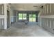 Large, unfinished living area with access to an outdoor deck through sliding glass doors at 59 Grove Township Way, Angier, NC 27501