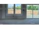 Bright living room featuring large windows and sliding glass doors leading to an outdoor deck at 59 Grove Township Way, Angier, NC 27501