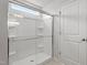 Modern shower enclosure with a built in bench, handheld sprayer, and glass door at 59 Grove Township Way, Angier, NC 27501