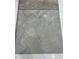 Close-up showcases a large square tile sample in neutral tones with a textured, stone-like appearance at 59 Grove Township Way, Angier, NC 27501