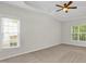 Spacious bedroom with natural light, neutral carpeting, and a tray ceiling at 6101 Clarks Fork Dr, Raleigh, NC 27616