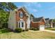 Exterior view of a two-story home showcasing its architectural design, brick accents, and well-maintained yard at 6101 Clarks Fork Dr, Raleigh, NC 27616