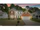 Charming two-story home with brick and siding, a well-manicured lawn, and an attached two-car garage at 6101 Clarks Fork Dr, Raleigh, NC 27616