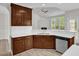 Well-lit kitchen features wood cabinets, white countertops, stainless steel appliances, and a view into the living room at 6101 Clarks Fork Dr, Raleigh, NC 27616