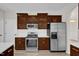 Updated kitchen with stainless steel appliances, wood cabinets, white countertops, and light wood flooring at 6101 Clarks Fork Dr, Raleigh, NC 27616