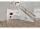 Spacious living room with open floor plan, staircase, and modern flooring connecting living spaces at 6101 Clarks Fork Dr, Raleigh, NC 27616