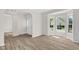 Bright living room featuring beautiful wood floors, neutral paint, large windows, and a welcoming entryway at 6101 Clarks Fork Dr, Raleigh, NC 27616