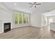Inviting living room featuring a fireplace, large windows, vaulted ceilings, and new flooring at 6101 Clarks Fork Dr, Raleigh, NC 27616