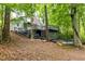 Exterior shot of the home, showcasing the deck and natural wooded backyard at 6409 Lakeland Dr, Raleigh, NC 27612