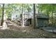 Multi-level deck and stairs leading to the yard surrounded by trees in a private, wooded setting at 6409 Lakeland Dr, Raleigh, NC 27612