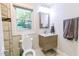 Bathroom featuring a vanity, mirror, and window with natural light at 6409 Lakeland Dr, Raleigh, NC 27612