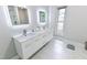 Bathroom with double sinks, marble countertop, and modern fixtures at 6409 Lakeland Dr, Raleigh, NC 27612