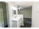 Bright bathroom features a white vanity with modern fixtures and a view to the bedroom at 6409 Lakeland Dr, Raleigh, NC 27612