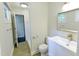 Modern bathroom with a white vanity, framed mirror, and tiled shower with glass door and brushed gold fixtures at 6409 Lakeland Dr, Raleigh, NC 27612