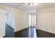 This bedroom has dark floors, neutral walls, a storage closet, and doorways that lead to other parts of the house at 6409 Lakeland Dr, Raleigh, NC 27612