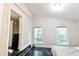 Bedroom with vaulted ceilings, large windows, and a closet at 6409 Lakeland Dr, Raleigh, NC 27612