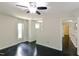This bedroom features dark wood floors, neutral walls, a ceiling fan and two windows providing natural light at 6409 Lakeland Dr, Raleigh, NC 27612