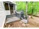 Multi-level deck leads to a cozy screened porch, surrounded by lush foliage and natural beauty at 6409 Lakeland Dr, Raleigh, NC 27612