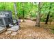 Wooded backyard offers privacy and charm, complemented by an inviting deck at 6409 Lakeland Dr, Raleigh, NC 27612