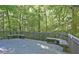 Spacious outdoor deck with built-in benches surrounded by lush trees, perfect for relaxation at 6409 Lakeland Dr, Raleigh, NC 27612