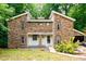 Beautiful two-story home with stone exterior, black-trimmed windows and attached garage at 6409 Lakeland Dr, Raleigh, NC 27612