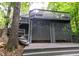 View of the home's exterior stairs and wooden deck, surrounded by lush trees at 6409 Lakeland Dr, Raleigh, NC 27612