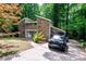 View of the home showcasing the stone facade and modern architectural details at 6409 Lakeland Dr, Raleigh, NC 27612
