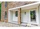 Inviting front porch with stone column detail and a gray painted entryway at 6409 Lakeland Dr, Raleigh, NC 27612