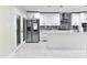 Bright, all-white kitchen featuring stainless steel appliances and a center island at 6409 Lakeland Dr, Raleigh, NC 27612