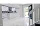 Spacious kitchen with white cabinets and a view of the front entry at 6409 Lakeland Dr, Raleigh, NC 27612
