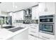 Bright kitchen with stainless steel appliances, double oven, and tile backsplash at 6409 Lakeland Dr, Raleigh, NC 27612